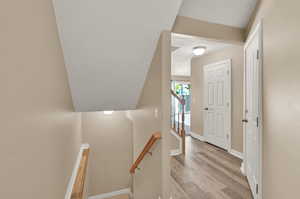 Stairway with hardwood / wood-style flooring