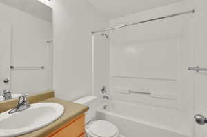 Full bathroom with vanity, bathtub / shower combination, and toilet