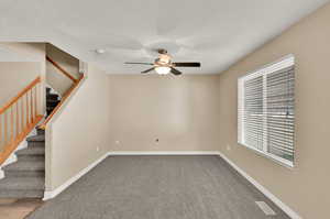 Carpeted spare room with ceiling fan