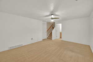 Unfurnished room with light carpet and ceiling fan