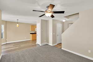 Unfurnished living room featuring light hardwood / wood-style flooring and ceiling fan