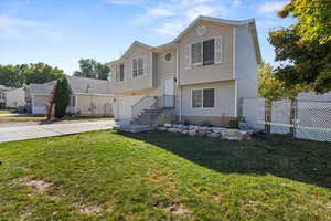 Bi-level home featuring a front lawn