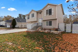 Split foyer home featuring a front yard and a garage