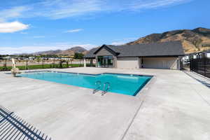 View of swimming pool featuring a mountain view and a patio