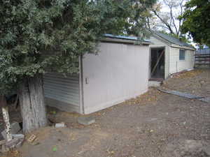 View of side of property featuring a storage unit