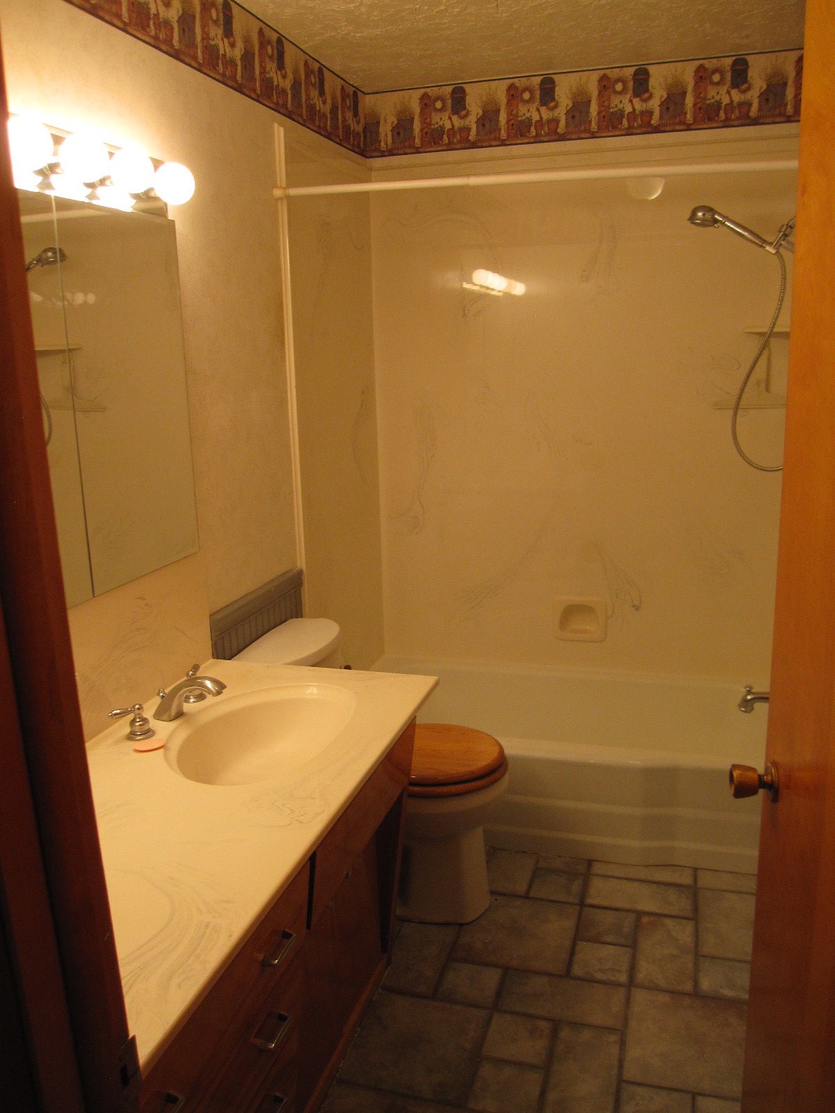 Full bathroom featuring vanity, a textured ceiling, shower / bathing tub combination, and toilet