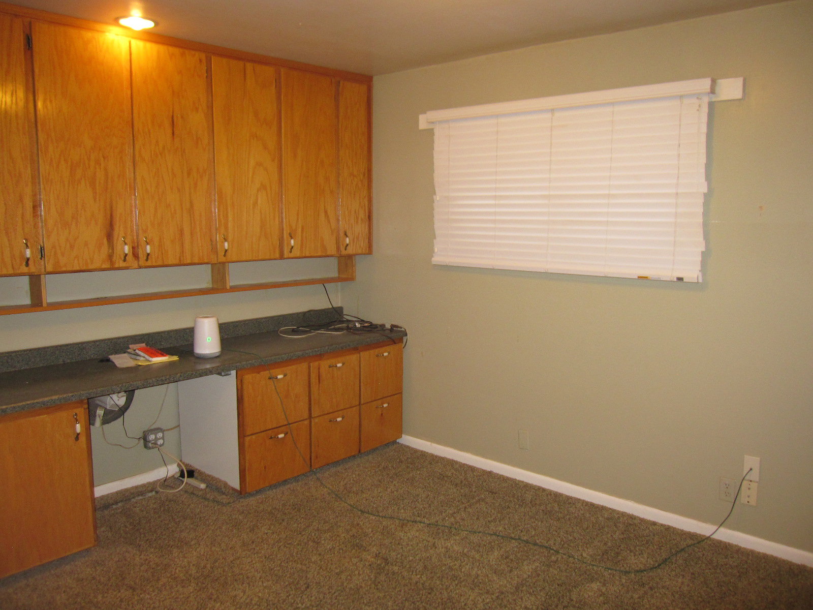 Unfurnished office with built in desk and dark carpet