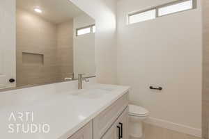 Bathroom with tile patterned flooring, vanity, and toilet