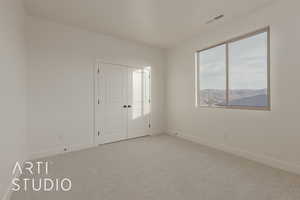 Unfurnished room with light colored carpet and a mountain view