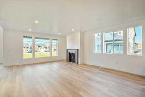 Unfurnished living room with light wood-type flooring