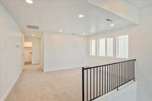 Corridor with light colored carpet