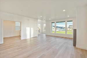 Unfurnished living room with light hardwood / wood-style floors