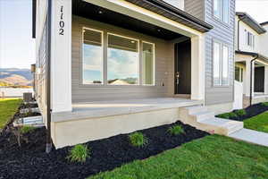 Property entrance featuring a porch and a lawn