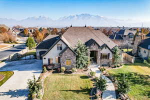 View of front of property with a mountain view and a front lawn