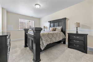 Carpeted bedroom featuring a textured ceiling