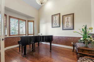 Miscellaneous room with hardwood / wood-style flooring and vaulted ceiling