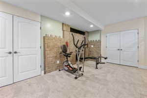 Workout area featuring light colored carpet