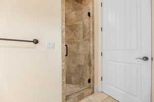 Bathroom with tile patterned flooring and walk in shower