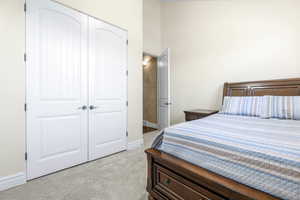 Carpeted bedroom with a closet