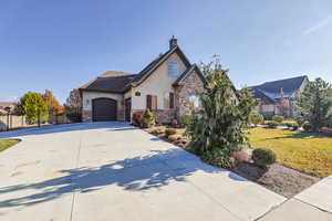 View of front of home featuring a front yard and a garage