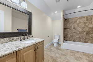 Full bathroom with tile patterned floors, vanity, toilet, and tiled shower / bath