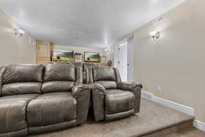 Home theater featuring a textured ceiling