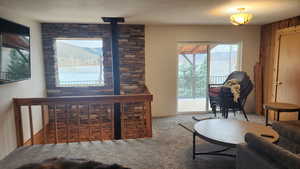 Carpeted living room with wood walls and a textured ceiling