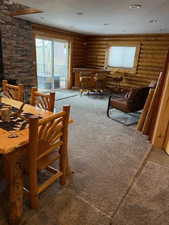 Sitting room featuring log walls and bar area