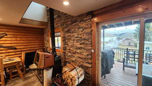 Interior space featuring hardwood / wood-style flooring, plenty of natural light, and rustic walls