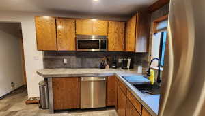 Kitchen with decorative backsplash and sink