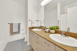 Primary Full bathroom featuring toilet, vanity, tile patterned floors, and separate shower and tub