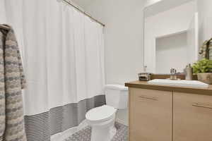 Hall Bathroom featuring vanity, a shower with curtain, and toilet