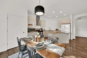 Dining area featuring sink and dark wood-type flooring