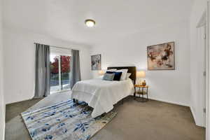 Primary Bedroom featuring carpet floors and access to outside