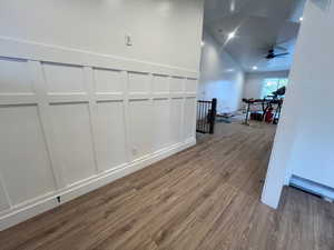 Hallway with hardwood / wood-style flooring