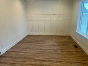 Unfurnished room with dark hardwood / wood-style floors