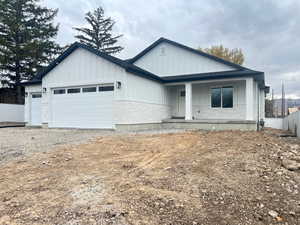 View of front of home with covered porch and a garage