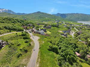 Birds eye view of property with a water and mountain view