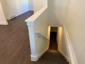 Stairway featuring hardwood / wood-style flooring