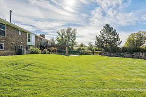 View of yard with central air condition unit and a deck