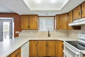 Kitchen featuring sink and white appliances