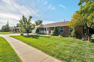 Ranch-style home with a front lawn