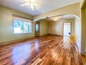 Interior space with hardwood flooring and ceiling fan