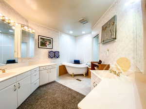 Bathroom with vanities and clawfoot bathtub