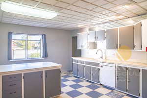 Kitchen with sink, gray cabinetry, and dishwasher