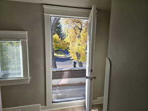 Doorway with light hardwood / wood-style flooring