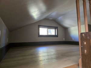 Bonus room featuring light hardwood / wood-style floors and vaulted ceiling