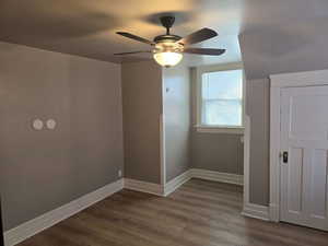 Bonus room with hardwood / wood-style floors and ceiling fan