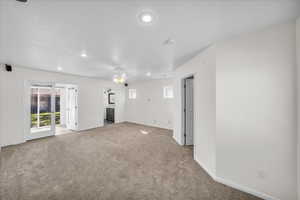 Empty room featuring carpet flooring and ceiling fan