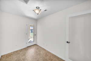 Empty room featuring a textured ceiling